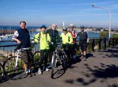 cyclists resting on fence